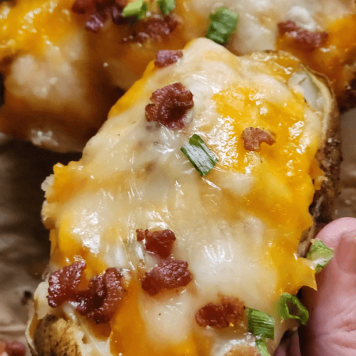 Cheesy twice-baked potatoes topped with crispy bacon, melted cheddar, and fresh green onions.