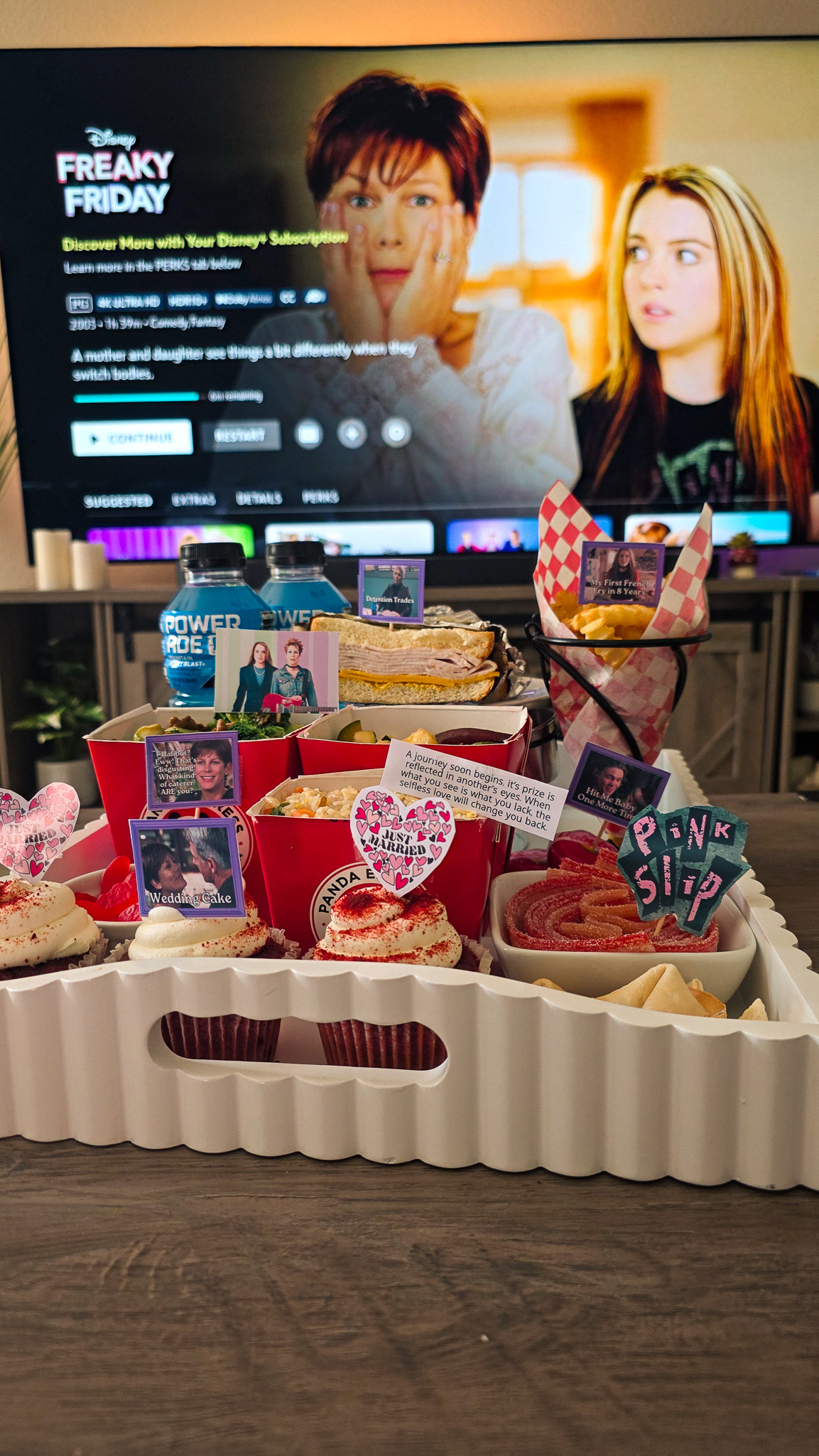 Freaky Friday movie night snack board in front of a TV showing the Freaky Friday menu screen on Disney+